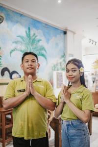 a man and a woman standing in a room with their hands together at Kayuma House Canggu in Canggu +62 photos
