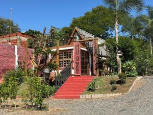 a house with a red staircase in front of it at Divina Cabana - Lago Corumbá IV - Alexânia (GO) in Alexânia