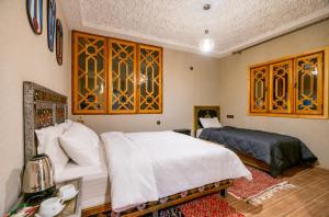 a bedroom with a bed and a couch and a table at Riad dreams imlil in Imlil
