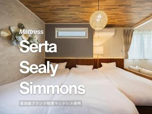 a bedroom with a large bed with white sheets at suite Funabashi LAGOON2 #201 in Funabashi +52 photos