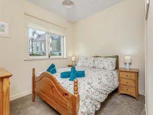 a bedroom with a bed and a window at Tanera in Wick +13 photos