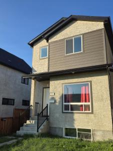 a house with a window and a staircase in it at The Lots home in Winnipeg
