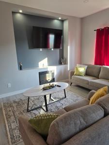 a living room with a couch and a table at The Lots home in Winnipeg