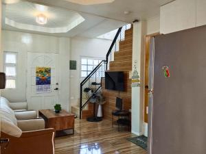 a living room with a couch and a staircase at Rustic Retreat room only in San Fernando