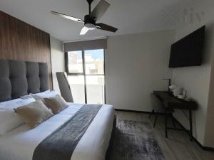 a bedroom with a bed with a ceiling fan and a desk at Private Room w/ Ensuite Bath & top Amenities in La Cañada +42 photos