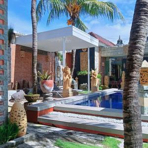 a house with a swimming pool and palm trees at Umah kampung8 in Mataram +37 photos