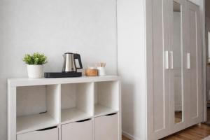 a white shelf with a coffee maker on it at Haus Wilbrand Ferienzimmer 1 in Warnemünde