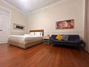 a bedroom with a bed and a couch at Andara Boutique Hotel in Lima