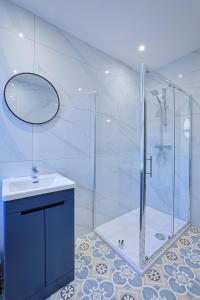 a bathroom with a shower and a sink at Gordon's Getaway Lux in Oban