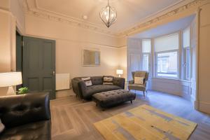 a living room with a couch and a chair at Gordon's Getaway Lux in Oban