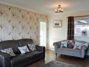 a living room with a couch and a chair at Glencairn Rd in Langbank
