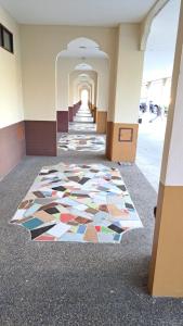 a hallway with a mosaic floor in a building at แอทประจวบ-At Prachuap in Prachuap Khiri Khan