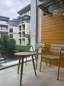 a table and chairs on a balcony with a window at Wyndham studio 2205 in Surin Beach