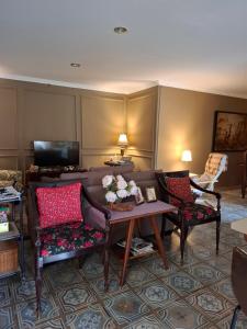 a living room with a couch and a table at ParabonHaus Kopitiam - Bed & Breakfast in Gegarbensang