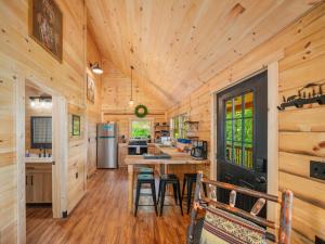 a kitchen with wooden walls and a wooden ceiling at The Three Dog Night Cabin in Bryson City