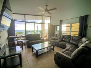 a living room with a couch and a table at Sky House in Rincon