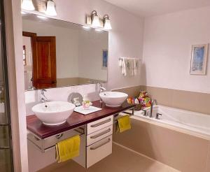 a bathroom with two sinks and a large mirror at Breathtaking Views Private 1 Bed Villa in Freetown Village