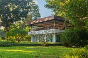 a house with a balcony in a park at Mae Jo Golf Resort & Spa in San Sai