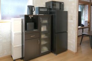 a kitchen with a refrigerator and a microwave at APROSTAY Fuji-kawaguchiko Aizen15 in Fujiyoshida