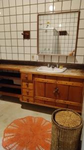 a bathroom with a sink and a mirror at Suite casa cachoeira in Paraty