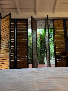 a bedroom with doors open to a garden at Juntas del Lago - Casa 2 in Apulo +48 photos