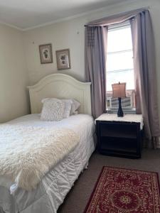 a bedroom with two beds and a window at Eden's Cozy Oasis in Windsor