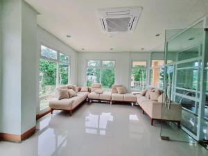 a large living room with couches and windows at B1 4Magnificent in Puerto Princesa City