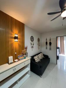 a living room with a couch and a ceiling fan at B1 4Magnificent in Puerto Princesa City +15 photos