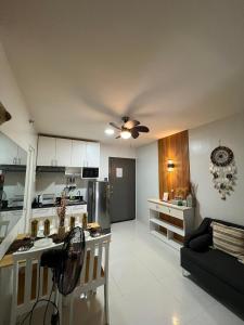a kitchen and living room with a ceiling fan at B1 4Magnificent in Puerto Princesa City