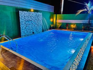 a large swimming pool in a room with a water feature at Shehan villa in Beruwala +26 photos