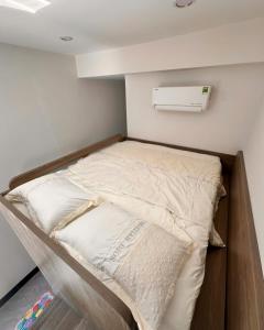 a bunk bed in a small room with aperature at Max Home in Ninh Hải