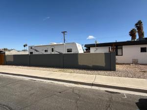 a fence on the side of a street next to a house at RV 2 min to Las Vegas Strip in Las Vegas