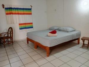 a bed in a room with a rainbow flag at Casa luci in Zipolite