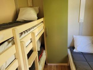 a small room with a bunk bed and a closet at Chalet Confortable avec Terrasse - 5 pers - API-1-52-1957 in Pamiers