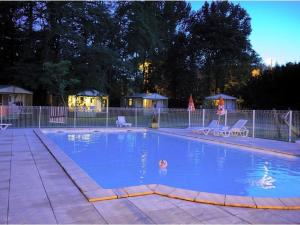 a swimming pool with chairs and a person in the water at Chalet Confortable avec Terrasse - 5 pers - API-1-52-1957 in Pamiers +28 photos