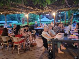a group of people sitting at tables in a restaurant at Chalet Confortable avec Terrasse - 5 pers - API-1-52-1957 in Pamiers