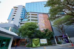 a building with a sign on the side of it at The Four Wings Hotel Bangkok in Bangkok