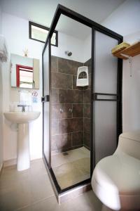 a bathroom with a shower and a sink at Finca La Playa Ecohotel - Experiencia Campestre - in Salento +76 photos