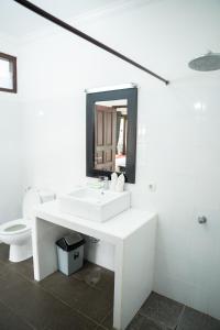 a white bathroom with a sink and a toilet at Tulamben Dive Resort in Tulamben +58 photos