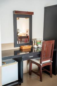 a desk with a chair and a mirror at Tulamben Dive Resort in Tulamben