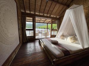 a bed with a hammock in a room with a view at Floating Paradise in Karimunjawa