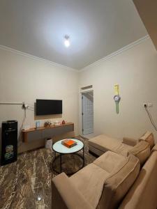 a living room with a couch and a table at patangpuluh homestay in Purwokerto