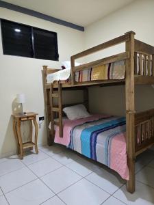 a bedroom with two bunk beds and a table at The Stone Way Suite in Juayúa