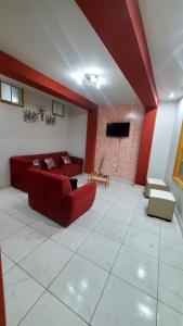 a living room with a couch and a flat screen tv at Departamento jaspe in Cajamarca