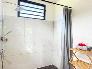 a bathroom with a shower with a glass door at Quiet house - great mountain view in Tiaraha +54 photos