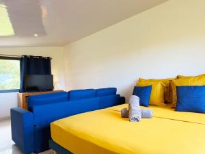 a living room with two beds and a blue couch at Quiet house - great mountain view in Tiaraha