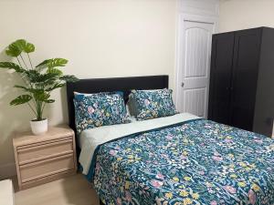 a bedroom with a bed and a potted plant at Cozy Home in Surrey