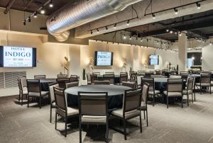 a group of tables and chairs in a room at Hotel Indigo Saint Louis Central West End by IHG in Saint Louis