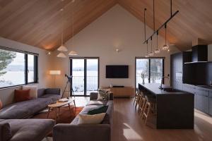 a living room with a couch and a table at Villa Matsu by H2 Life in Nakafurano