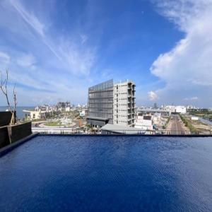 a large pool of water in front of a building at Delf Apartement Cpi Mewah By Selfiyani in Makassar